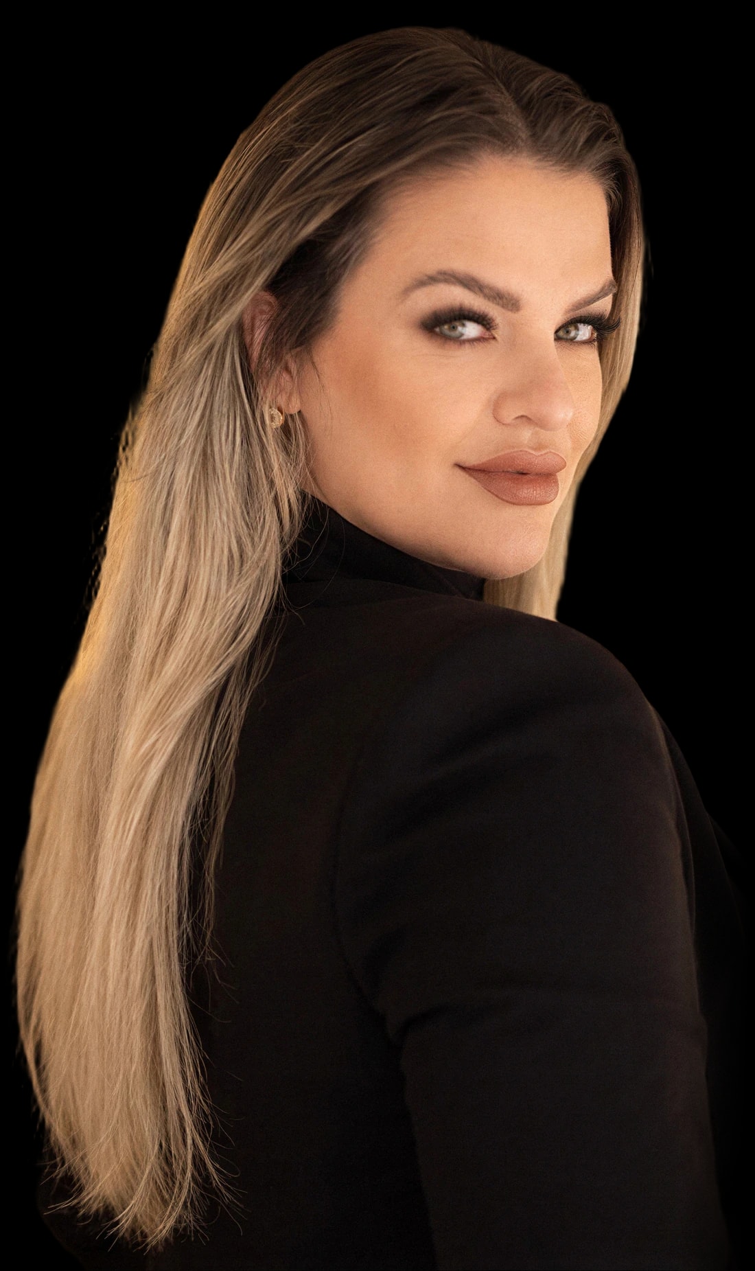 Daniela Silva olhando por sobre o ombro, de blazer preto